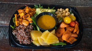 il porcellino salumi's vegetarian power bowl pictured at an angle from above on a wood table.