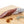 Load image into Gallery viewer, A picture of a spicy salami called Diablo salami by il porcellino salumi shot from the side and cut into slices on a cutting board.