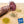 Load image into Gallery viewer, A close up picture looking at the cross section of il porcellino salumi&#39;s Finocchiona salami. Half of the salami is a whole chub and the other half is cut into slices on a cutting board with herbs and spices. Plus the Good Food Award Finalist 2021 seal is placed on the picture.
