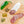Load image into Gallery viewer, A product photo of green chile tequila salami shot from above. Half of the salami is whole and the other half is cut into slices on a cutting board with a green chile, herbs and spices.