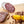 Load image into Gallery viewer, A close up picture of a cross section of lemongrass szechuan peppercorn salami with herbs and spices in the foreground.