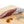 Load image into Gallery viewer, A picture of a spicy salami called Diablo salami by il porcellino salumi shot from the side and cut into slices on a cutting board.
