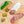 Load image into Gallery viewer, A product photo of green chile tequila salami shot from above. Half of the salami is whole and the other half is cut into slices on a cutting board with a green chile, herbs and spices.
